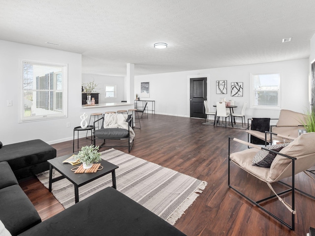 living room featuring hardwood / wood-style floors and a textured ceiling