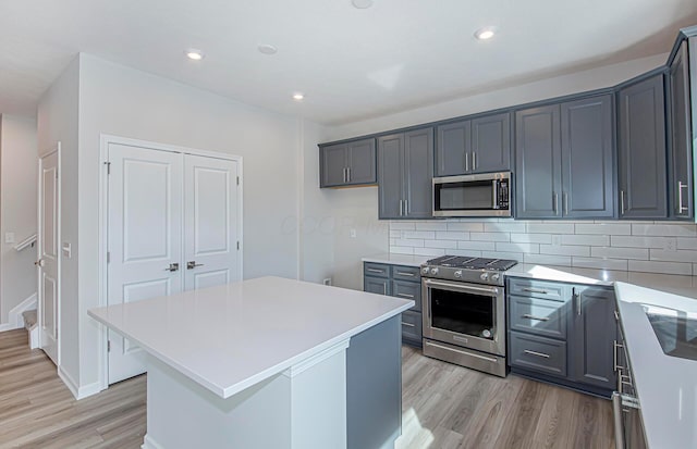 190 Franks Field Dr Lot 13918, Delaware, OH 43015 - kitchen featuring light countertops, decorative backsplash, appliances with stainless steel finishes, and light wood-style floors