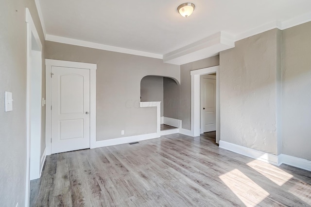 spare room with crown molding and light hardwood / wood-style floors