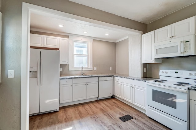 kitchen with sink, white cabinets, white appliances, and light wood-type flooring