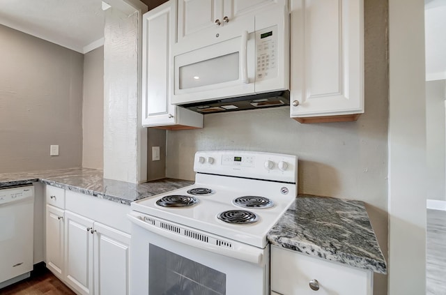 kitchen with stone counters, white appliances, and white cabinetry