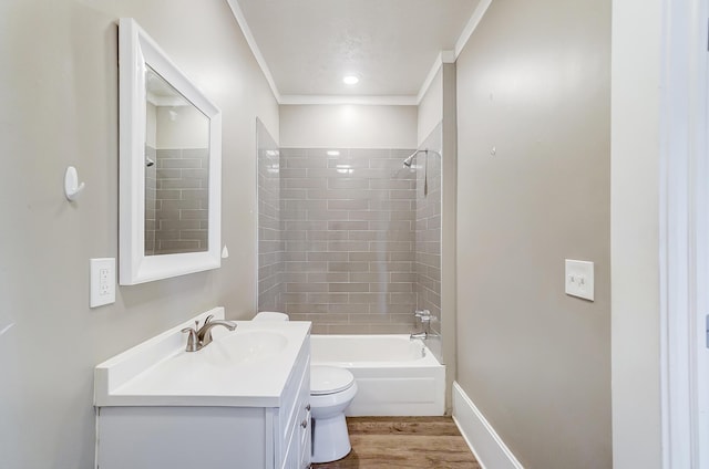 full bathroom with vanity, crown molding, hardwood / wood-style flooring, toilet, and tiled shower / bath