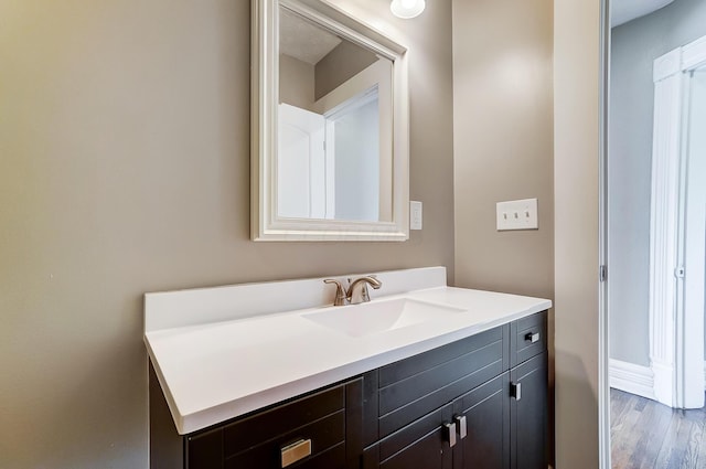 bathroom featuring hardwood / wood-style flooring and vanity