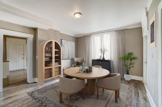 dining space with light hardwood / wood-style floors