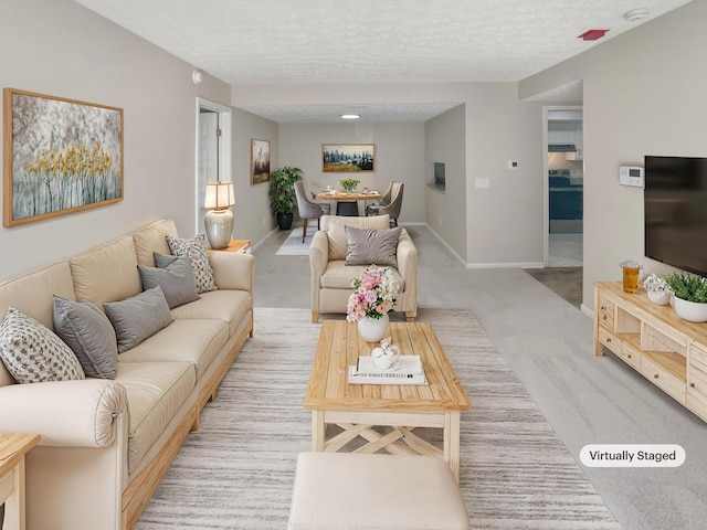 living room with light colored carpet and a textured ceiling