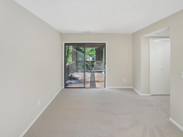 unfurnished room with light carpet