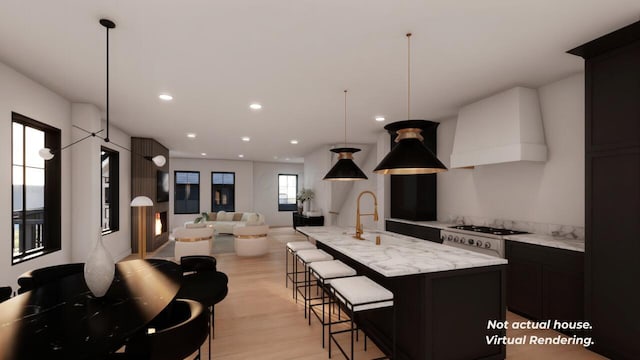 kitchen with pendant lighting, sink, a healthy amount of sunlight, and custom exhaust hood