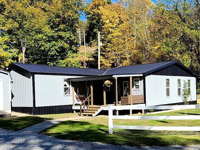 view of front of property with a front yard and covered porch