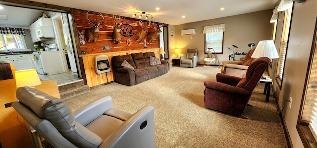 carpeted living room with a workshop area, heating unit, a wall unit AC, and wood walls