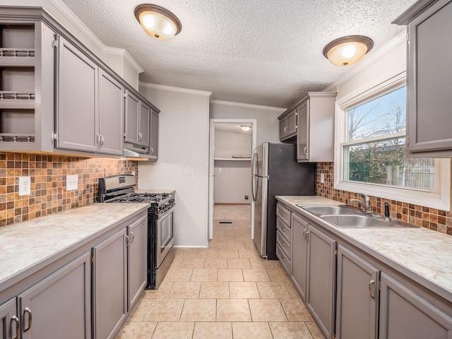 kitchen featuring gray cabinetry, sink, stainless steel appliances, light tile patterned floors, and ornamental molding