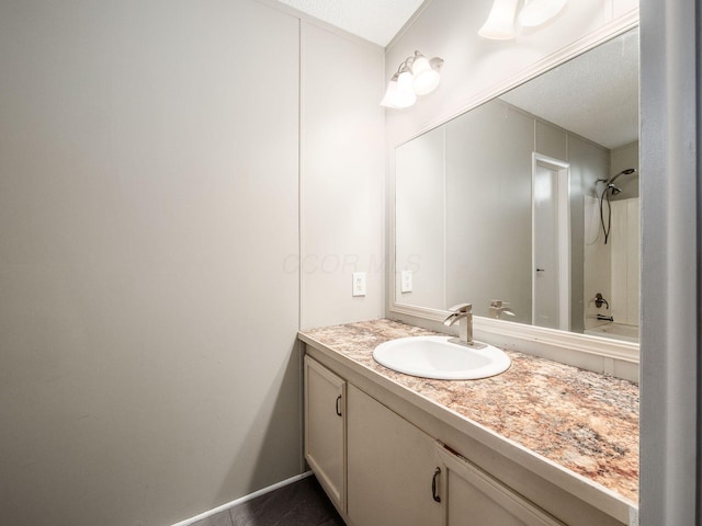 bathroom with tile patterned floors, vanity, and  shower combination