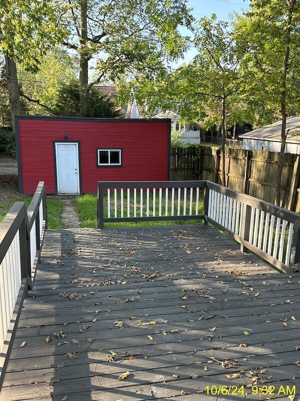 wooden terrace with an outbuilding