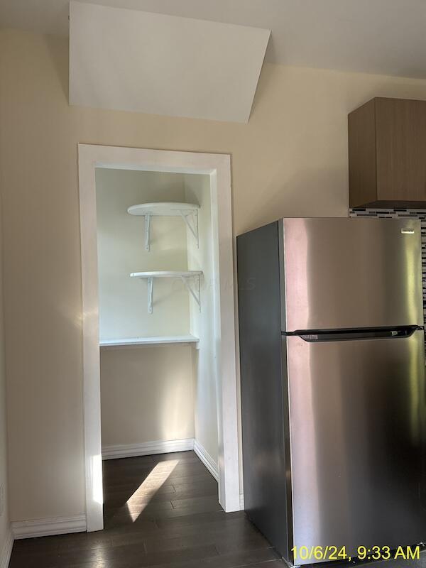 kitchen featuring stainless steel refrigerator and dark wood-type flooring