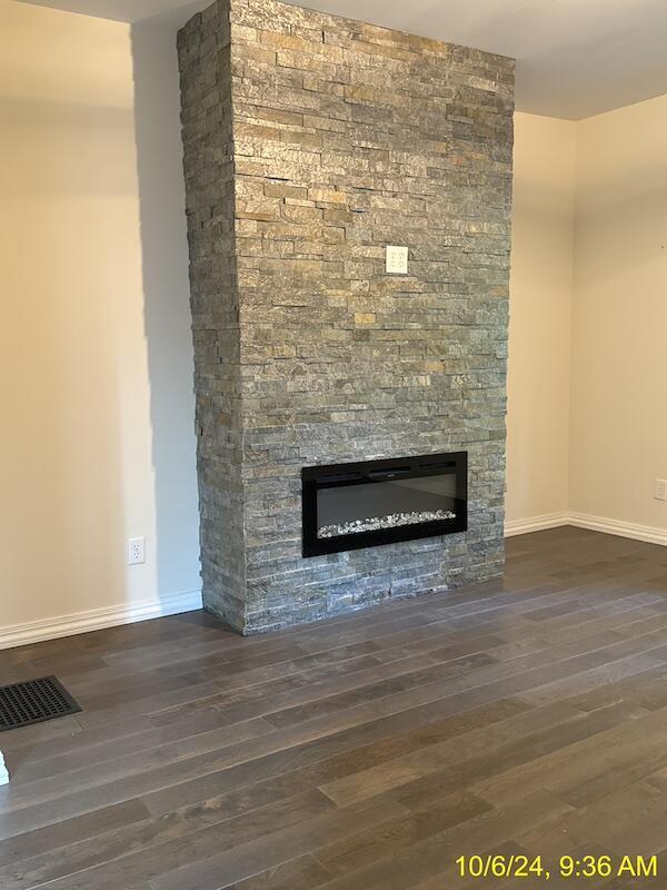 room details with a fireplace and hardwood / wood-style floors