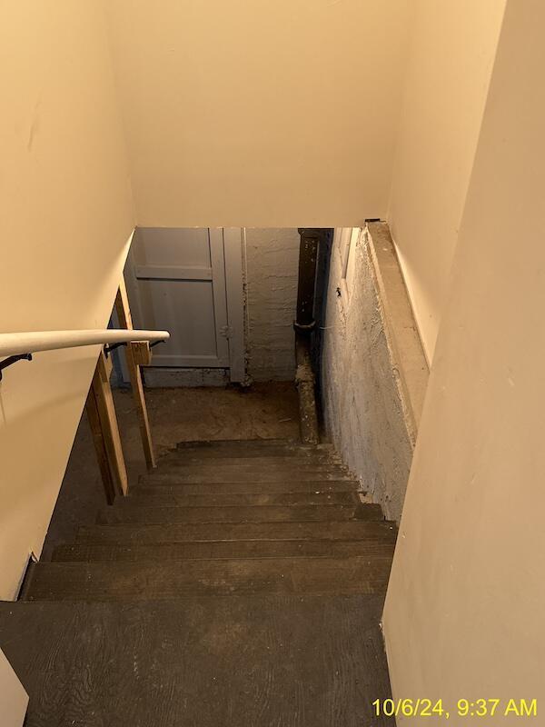 stairs featuring wood-type flooring