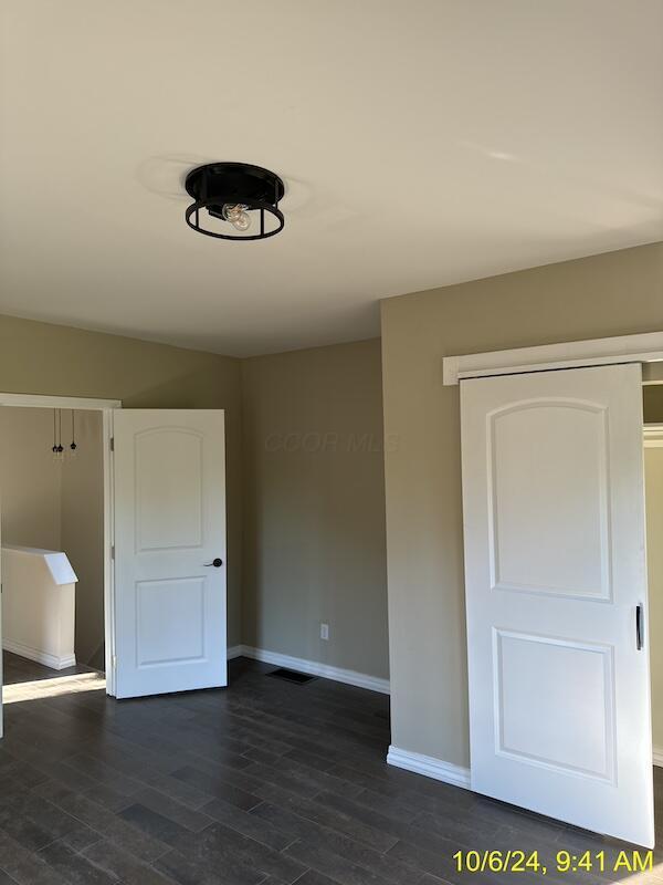 empty room featuring dark hardwood / wood-style flooring