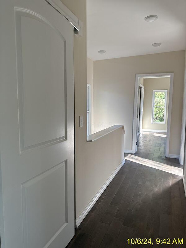 hallway with dark hardwood / wood-style floors