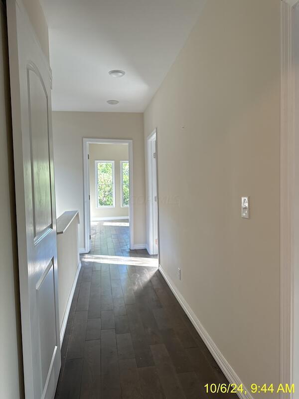 hallway with dark wood-type flooring