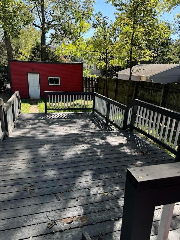 wooden terrace featuring an outdoor structure