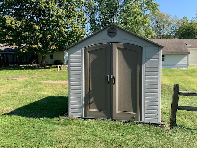 view of outbuilding with a lawn