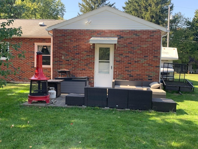 back of property featuring an outdoor living space and a yard