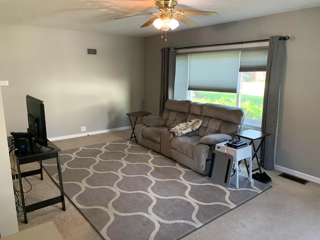 carpeted living room with ceiling fan