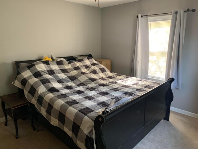 bedroom featuring light colored carpet