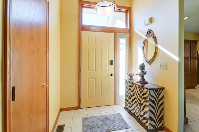 entrance foyer with light tile patterned floors, plenty of natural light, and lofted ceiling