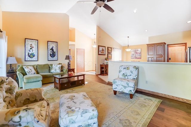 living room featuring ceiling fan, high vaulted ceiling, and light hardwood / wood-style flooring