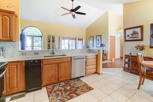 kitchen with ceiling fan, sink, high vaulted ceiling, stainless steel dishwasher, and light tile patterned floors