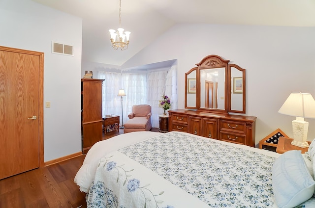 bedroom featuring dark hardwood / wood-style floors, an inviting chandelier, and lofted ceiling