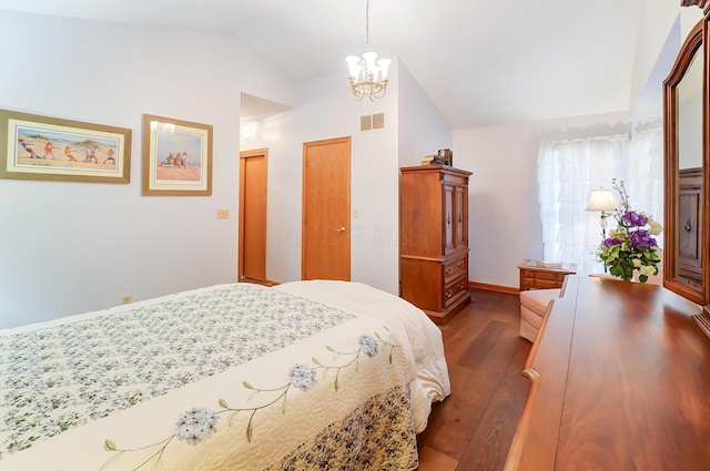 bedroom with a notable chandelier, lofted ceiling, dark wood-type flooring, and a closet