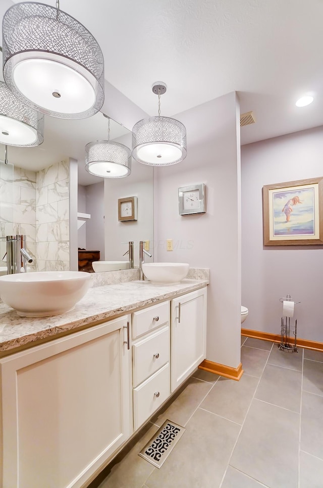 bathroom featuring toilet, vanity, and tile patterned floors