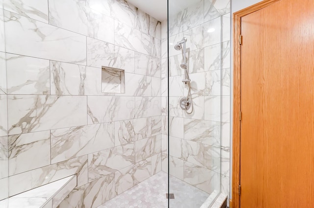 bathroom with a tile shower