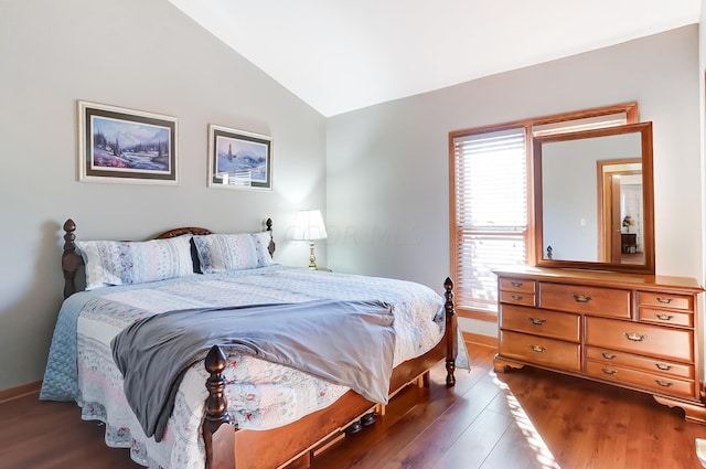 bedroom featuring dark hardwood / wood-style floors and lofted ceiling