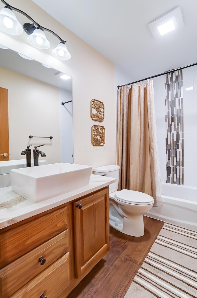 full bathroom with toilet, vanity, shower / bath combination with curtain, and hardwood / wood-style flooring