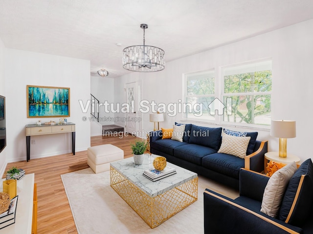 living room with hardwood / wood-style floors and a notable chandelier