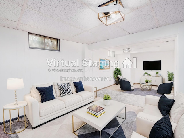 living room featuring a paneled ceiling