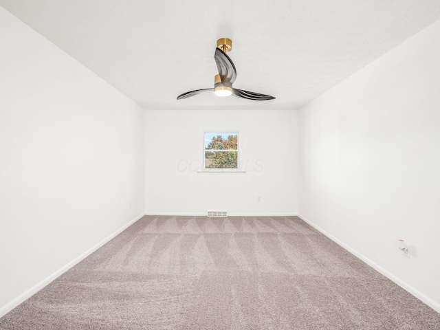 spare room with carpet flooring and ceiling fan