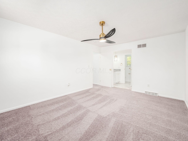 empty room with light colored carpet and ceiling fan