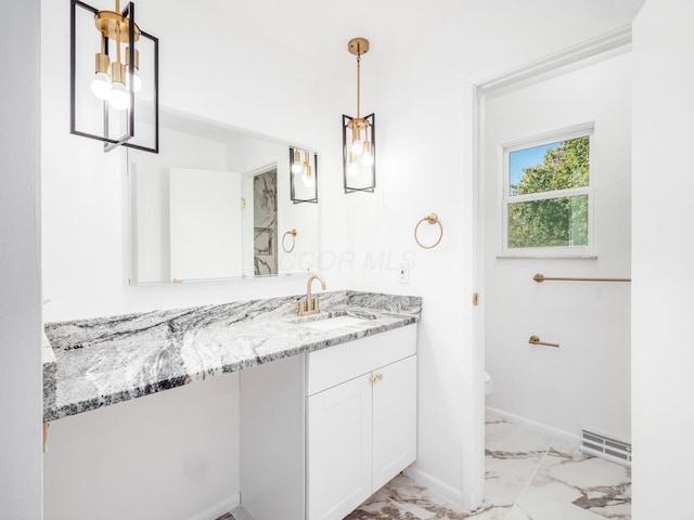 bathroom with vanity and toilet