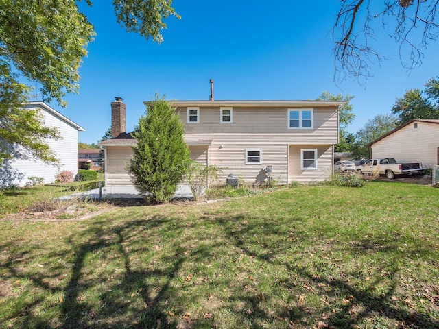 rear view of property with a yard