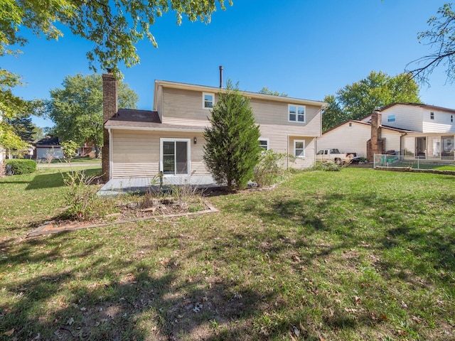 rear view of house with a yard