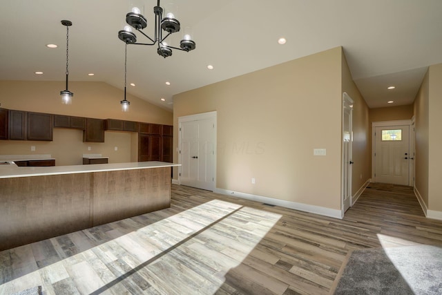32360 Redbud Ln, Logan, OH 43138 - kitchen featuring light wood-type flooring, recessed lighting, vaulted ceiling, pendant lighting, and a chandelier