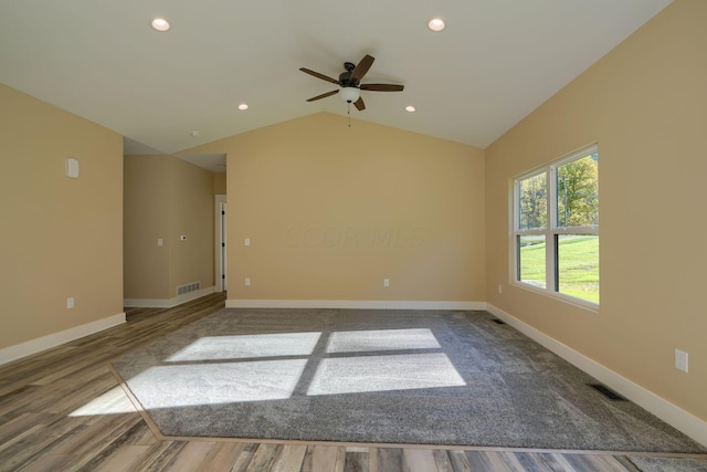 spare room featuring hardwood / wood-style floors, ceiling fan, and vaulted ceiling