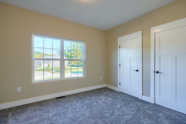 32360 Redbud Ln, Logan, OH 43138 - unfurnished bedroom featuring dark colored carpet and baseboards