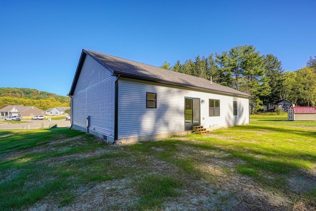 view of property exterior with a yard