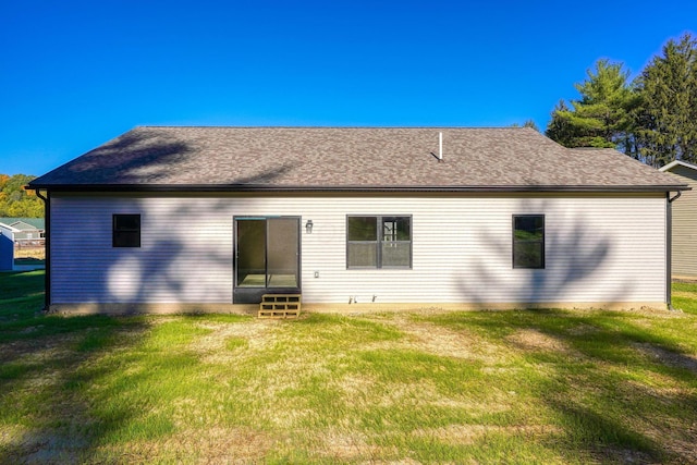 back of property featuring a lawn