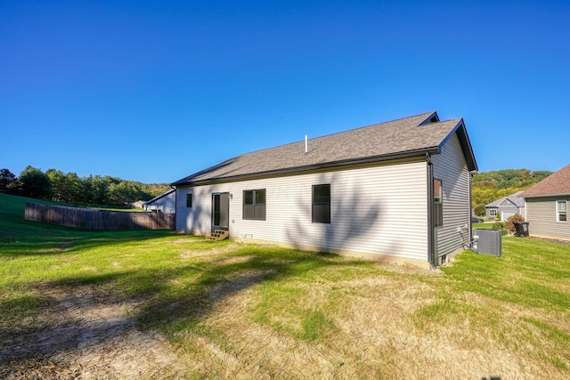 rear view of house with a yard