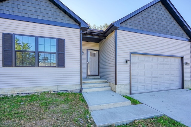 view of exterior entry with a garage